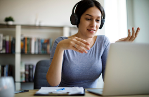 Woman On Laptop With Headphones Talking