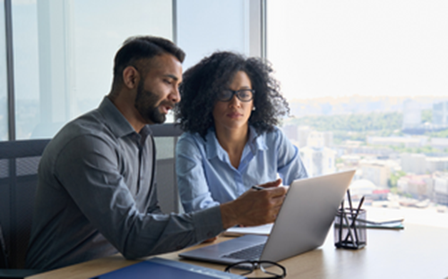 Man and a women working on a laptop together