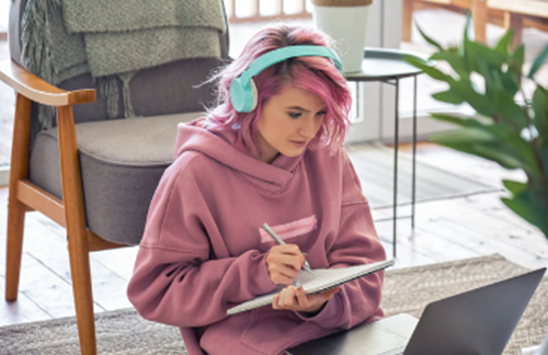 Woman Wearing Pink Hoodie And Pink Hair Writing On Notepad