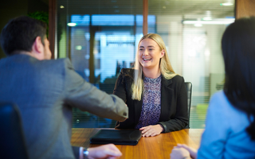 Smiling employees shaking hands