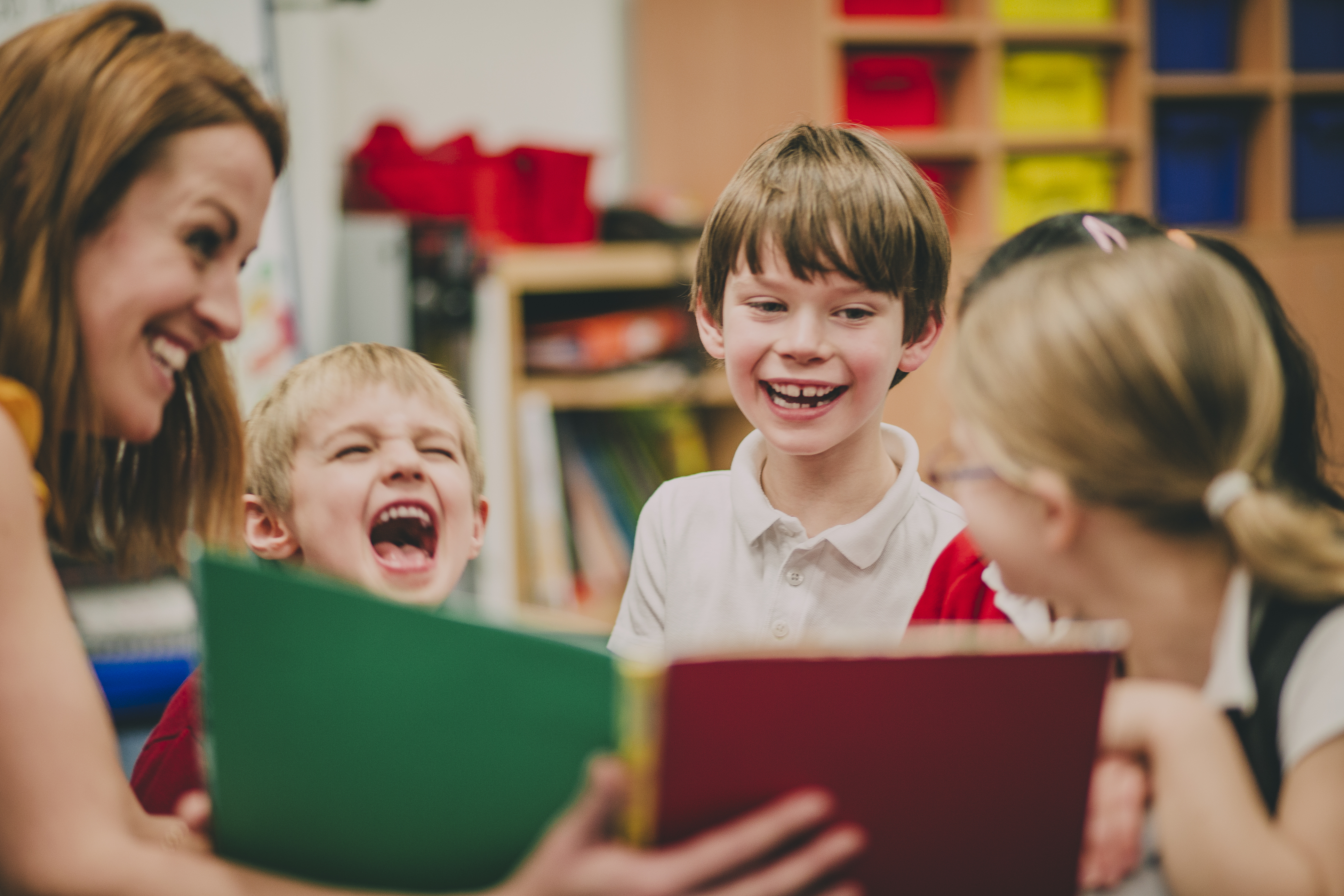 Woman reading book to children