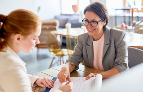 Lady helping a younger worker