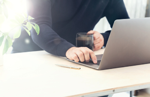 Person Using Laptop At Home