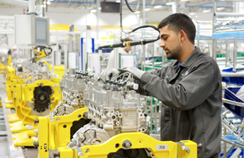 Man Working On Engine Production Line